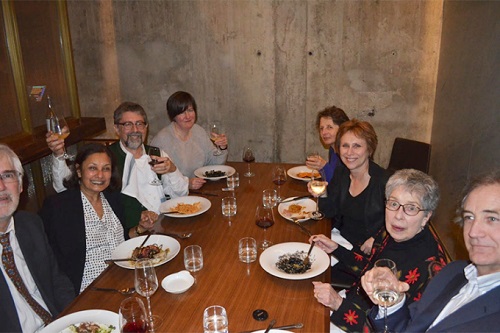 Jane Millgate and other Walter Scott scholars seated around a wooden table at a restaurant