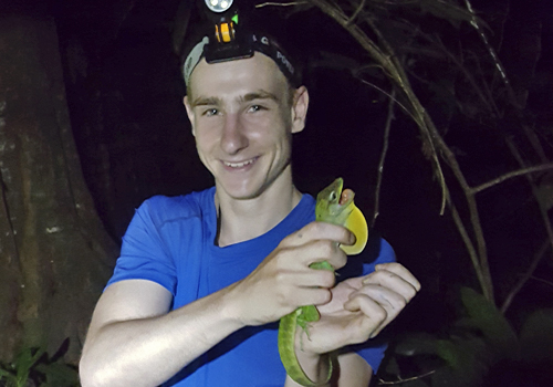 George Sandler getting up close and personal with an Anolis lizard in the rainforest. Photo courtesy of George Sandler.