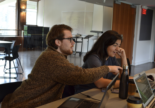 two students looking at a computer