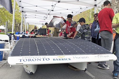 Members of the Blue Sky Solar Racing team with their solar powered vehicle