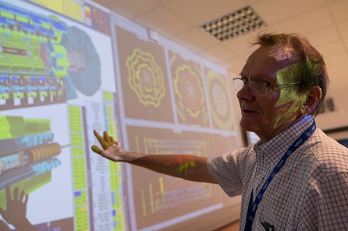 Pekka Sinervo pointing to a projector screen