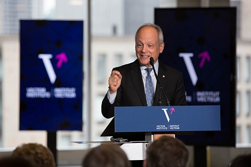 Meric Gertler speaking at a podium