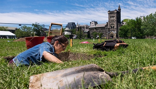 Corinne Harrilall digging with University College in the background