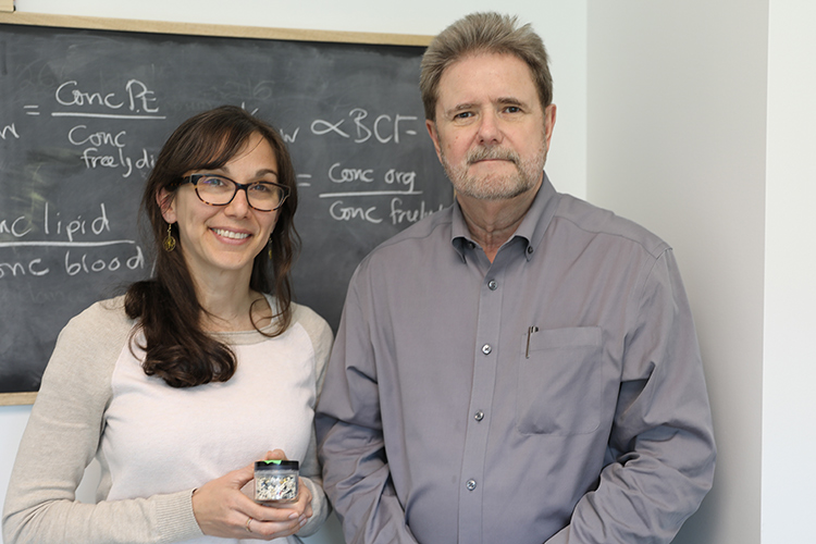 Chelsea Rochman holding a small jar of plastic particles next to Bob Andrews