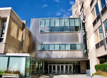 The entrance of Sidney Smith building on a sunny day.