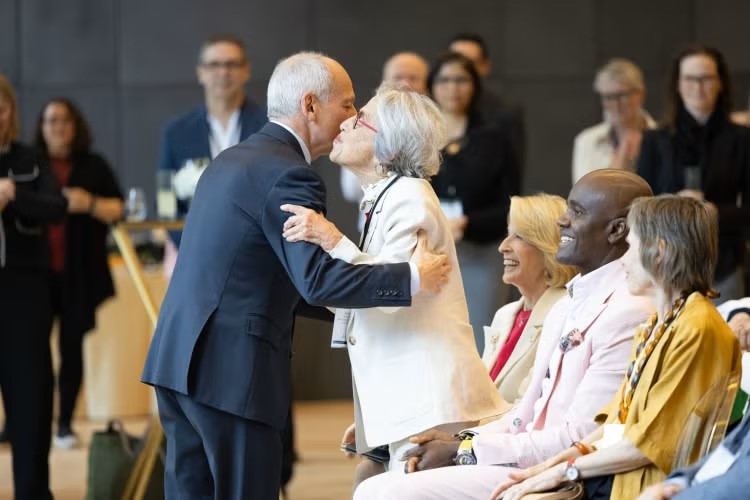 President Meric Gertler embraces Professor Janice Stein.