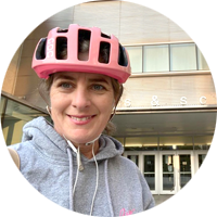 Dean Melanie Woodin with a pink bike helmet.