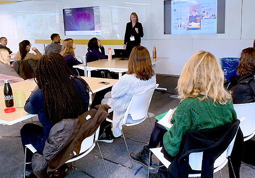 Heidi Pepper Coles presenting information to a group of people.