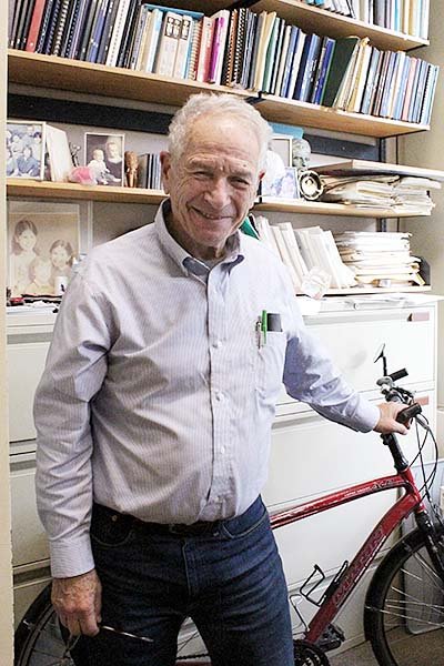 Allan Borodin standing with a bicycle.