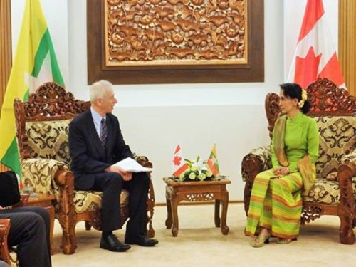 Canadian Foreign Minister Stephane Dion with Burma’s Foreign Minister Aung San Suu Kyi seated in ornate chairs during a bilateral meeting.