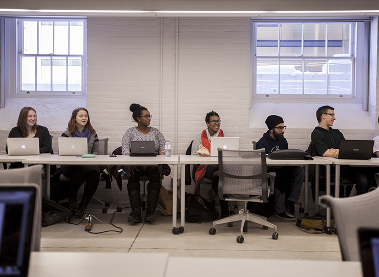 Students seated in a row in a seminar room