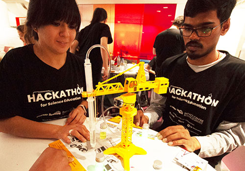 Martha Flores and Abhinav Anand of team Atoms Family put the finishing touches on their award-winning robotic crane