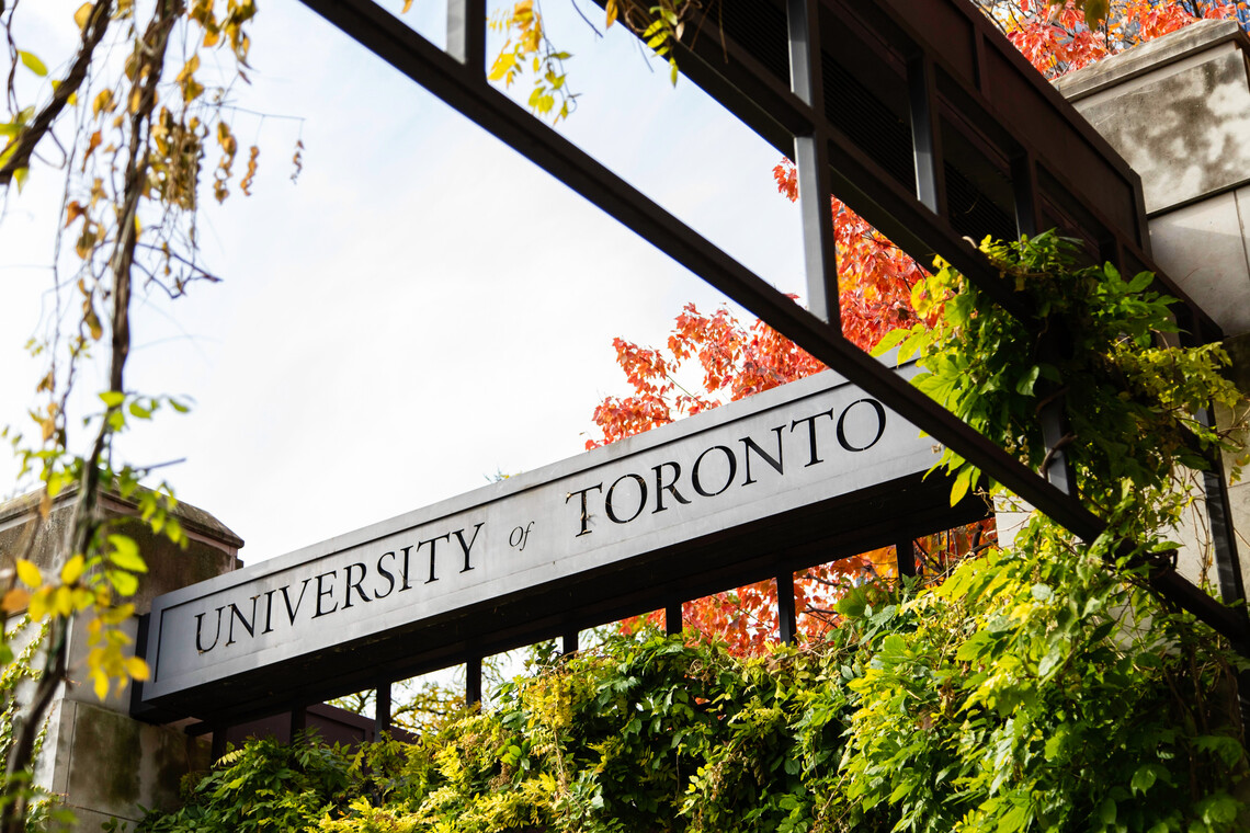 University of Toronto sign surrounded by fall foliage