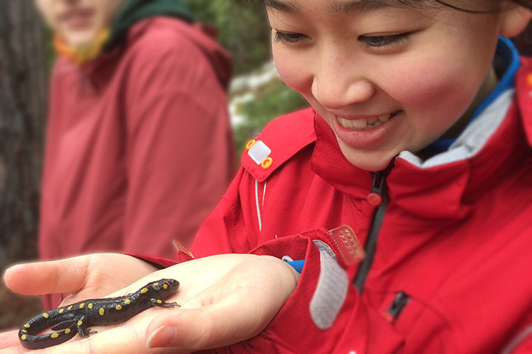 Student holding a lizard on her palm