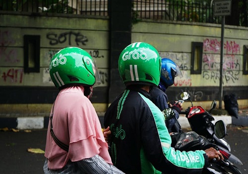 Grab driver and passenger on a moped.
