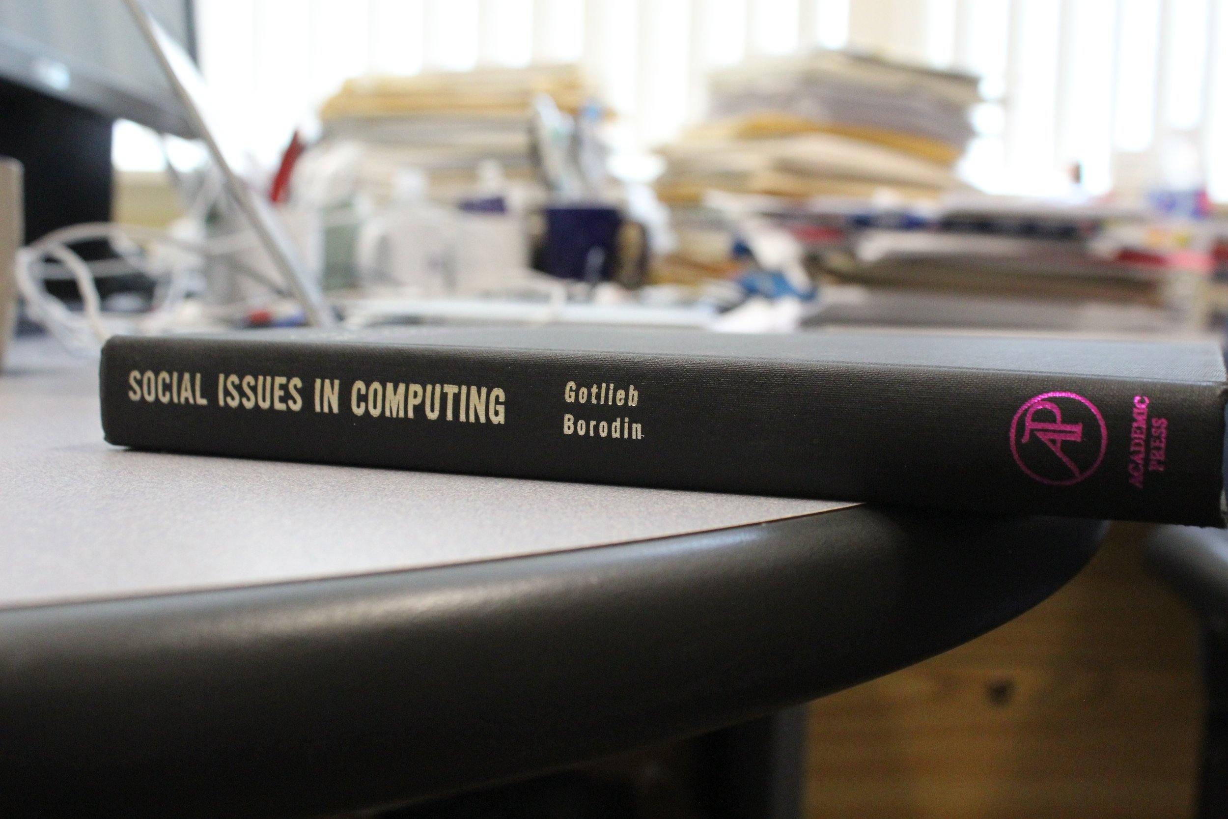 Social Issues in Computing book on a desk in an office.