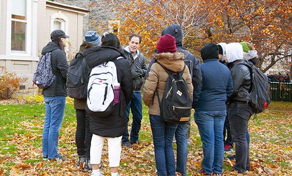 Jon Johnson gives a tour to a group of students at Johnson MacDonald House.