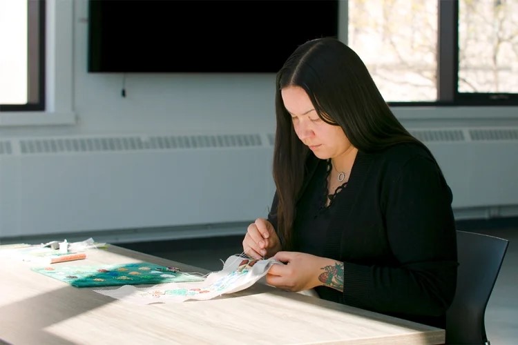 Katie Longboat creating the Indigenous stole.