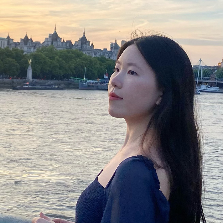Photo of Laura Chen, psychology peer mentor, outdoors in front of a river