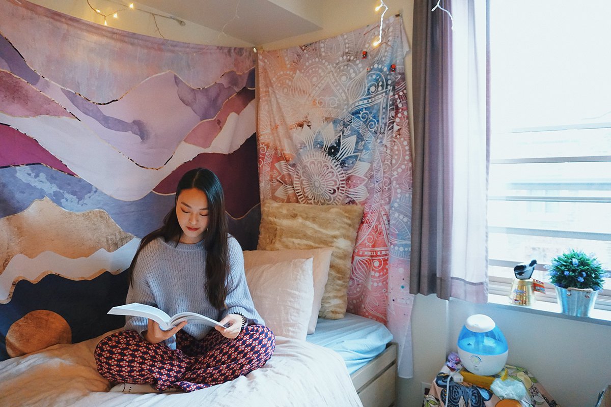 student reading in dorm room