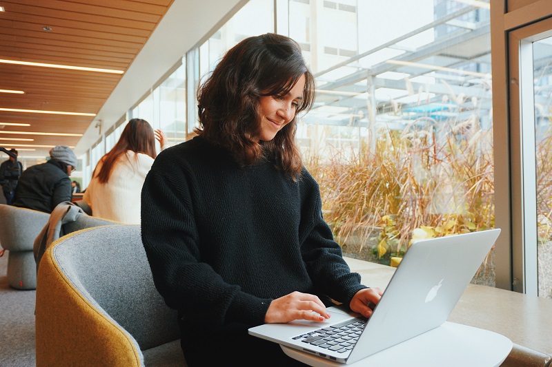 Student on a laptop in the Sidney Smith Commons