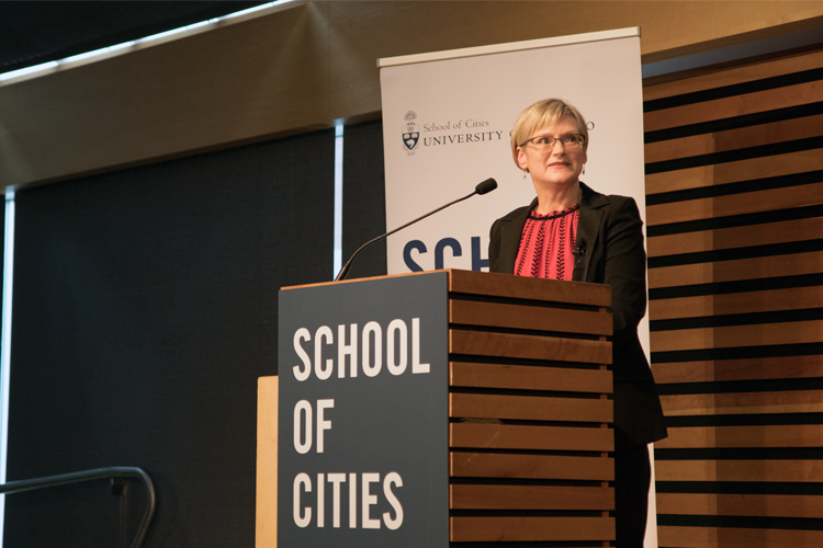 Michelynn Lafleche standing at a podium