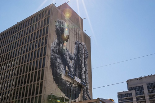 Mural by Phlegm on the side of a building.