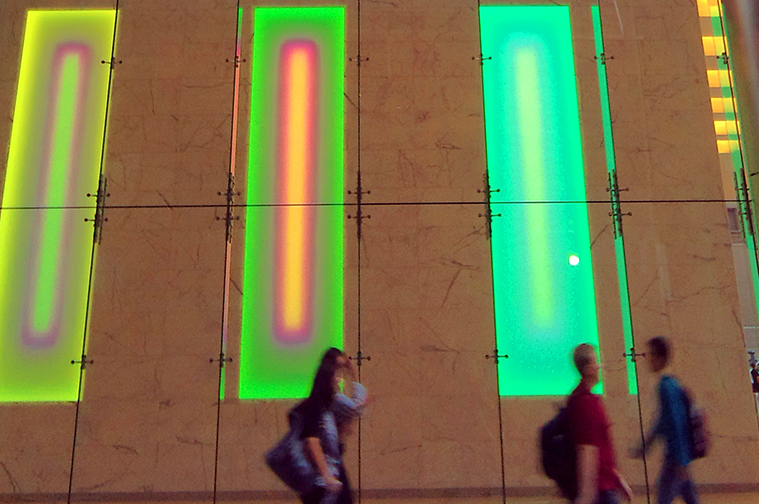 Green and red light installation on side of the building 