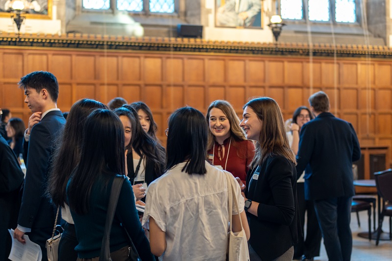 Group of students at a networking event inside Hart House