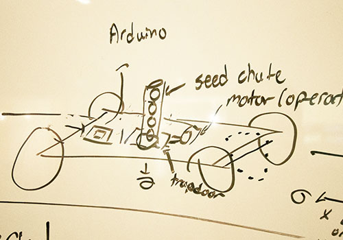 Concept art and an illustration of a seed chute that looks like a cannon on wheels.