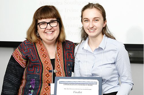 Photo of student receiving an award from a faculty member