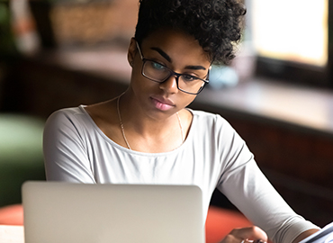 A person looking at a laptop screen.