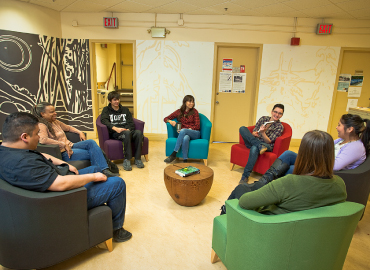 A group of people sitting in chairs in a circle at the Centre for Indigenous Studies