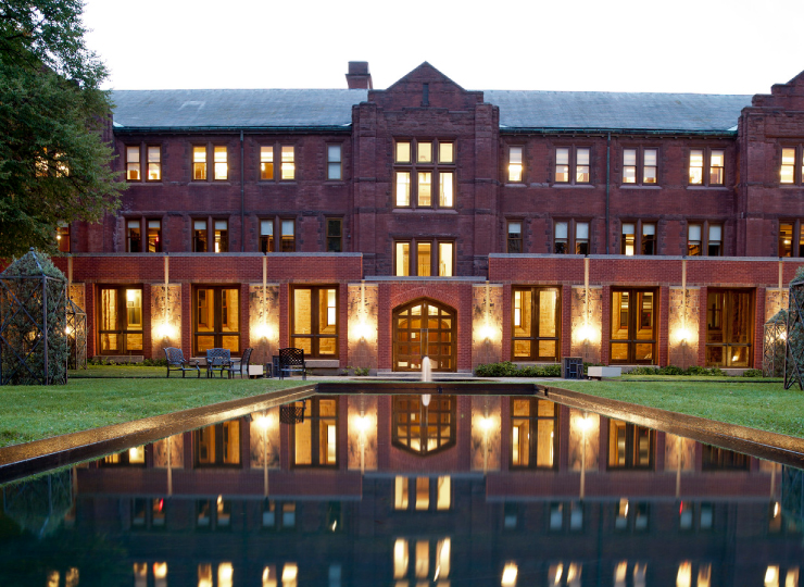 An exterior view of Munk School of Global Affairs & Public Policy on a summer night.