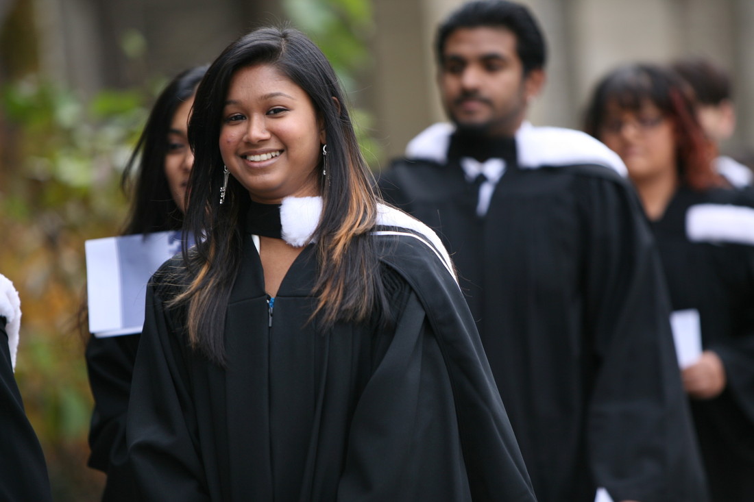 Photo of female graduand in the convocation procession