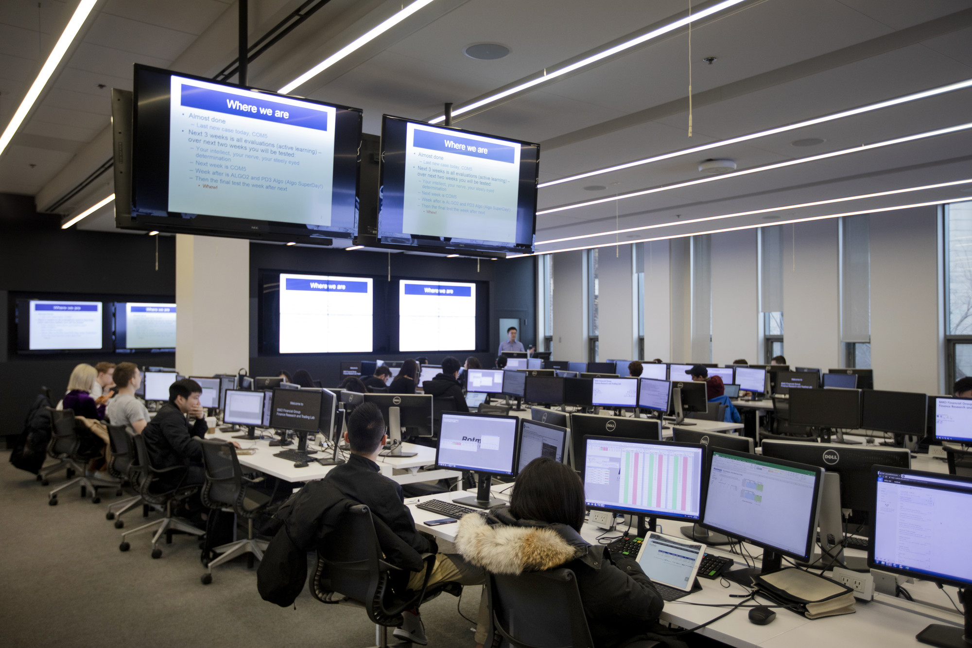 Students on computers inside the Rotman Finance Lab