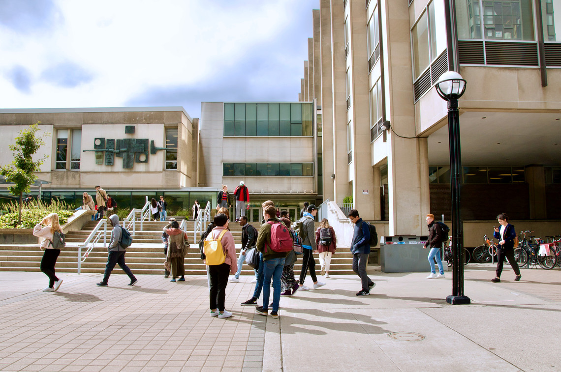 Students talking in front of Sidney Smith Hall