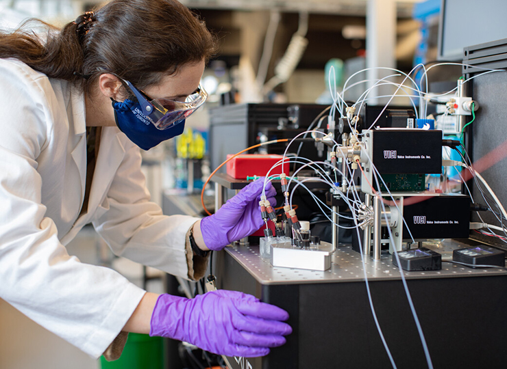 A person in a lab completing research.