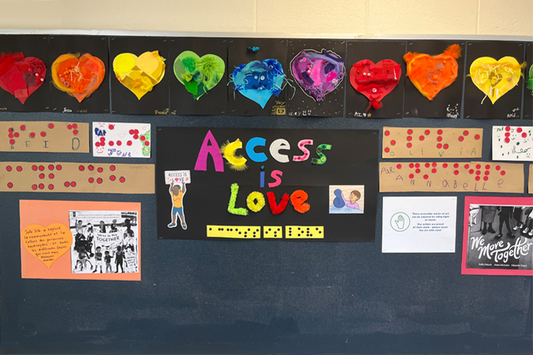 A bulletin board with rainbow cut out letters that say, "Access is love."