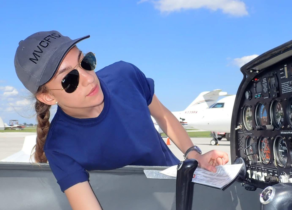 Adele Crete-Laurence looking a plane's cockpit