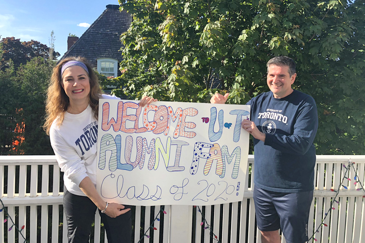 Lucianna Ciccocioppo poses with a handmade congratulatory banner for 2020 graduates