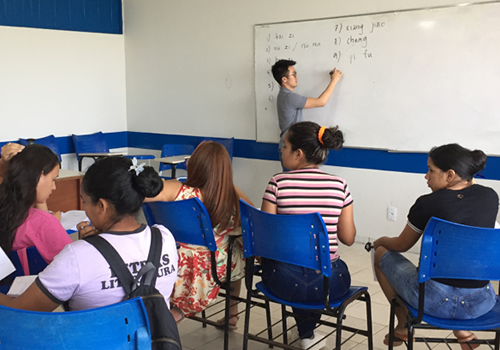 Gregory Antono writing on a whiteboard