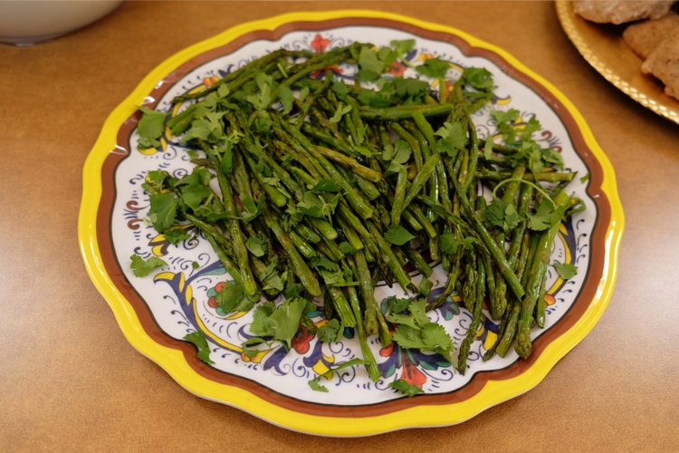 A plate of asparagus on a patterned yellow plate