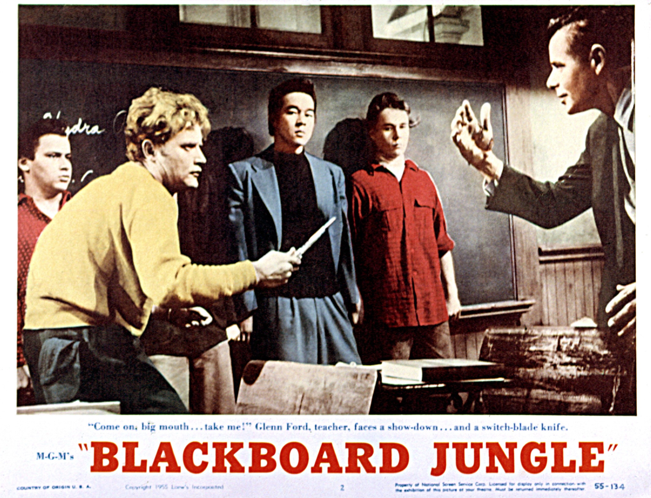 A still from the movie Blackboard Jungle where a student is menacing at a teacher