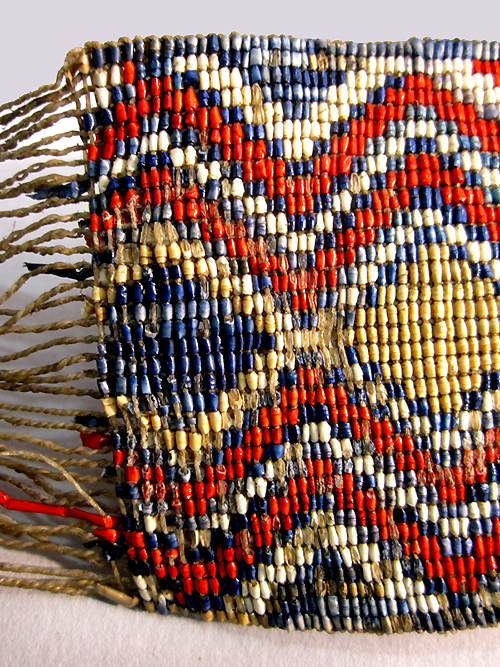 A beaded belt with a colourful zig-zag pattern.