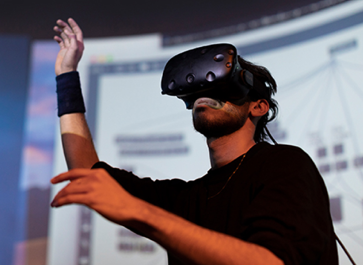 A person on stage with digital goggles.