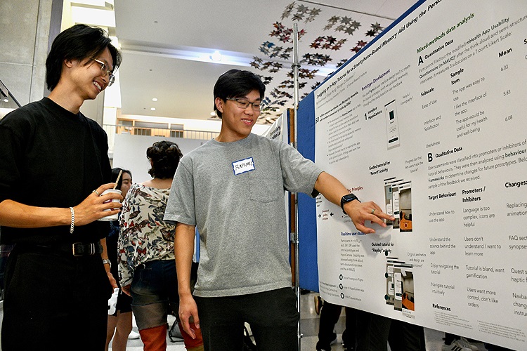 Bryan Raphael standing beside his research slide