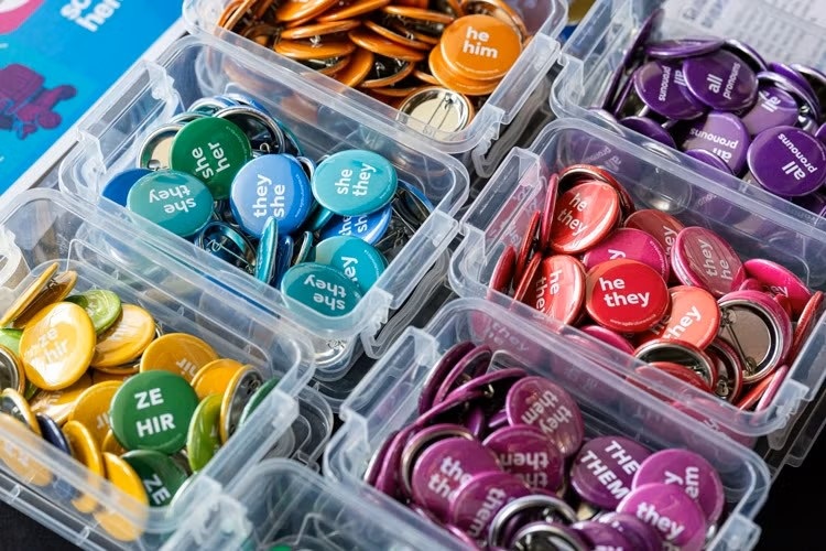 Colourful pride buttons on a table.