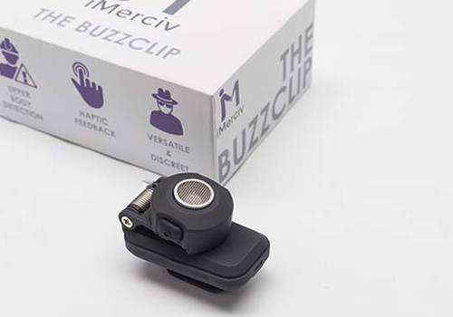 A white box with a blue illustrations including a caution sign, touch and person in a hat. A small black clip is beside the box, known as a BuzzClip.