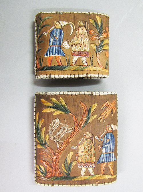 A cigar case with beautiful embroidered people and plants.